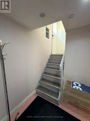 Toronto (Dorset Park) apartment for rent - A staircase in a room with a sign that says "CE".