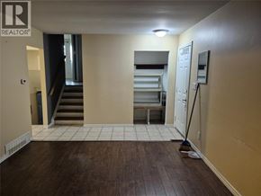 Sarnia apartment for rent - A room with a brown floor and a white door.