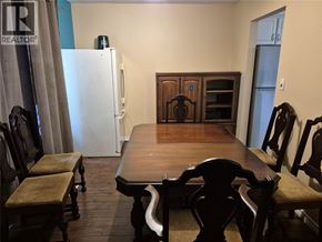 Sarnia apartment for rent - A dining room with a wooden table and chairs.