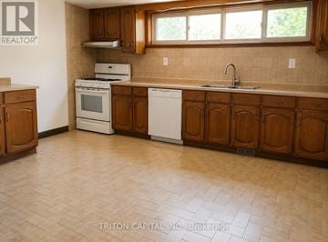 Vaughan (East Woodbridge) apartment for rent - A kitchen with wooden cabinets and a tile floor.