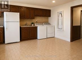 Vaughan (East Woodbridge) apartment for rent - A kitchen with a white refrigerator, a white washing machine, and a white dishwasher.