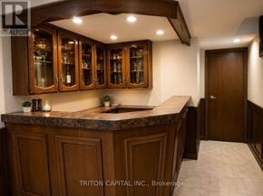 Vaughan (East Woodbridge) apartment for rent - A kitchen with wooden cabinets and a marble countertop.