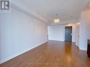 Mississauga (City Centre) condo for rent - A room with wooden floors and a chandelier hanging from the ceiling.