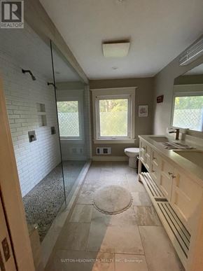 Caledon (Cheltenham) apartment for rent - A bathroom with a glass shower door and a toilet.