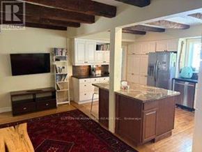 Caledon (Cheltenham) apartment for rent - A kitchen with a refrigerator, cabinets, and a countertop.