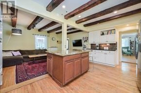 Caledon (Cheltenham) apartment for rent - A kitchen with a wooden island and a living room with a couch.
