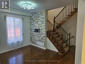 Mississauga (Churchill Meadows) apartment for rent - A room with a stone wall and a staircase.