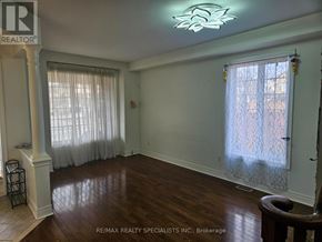 Mississauga (Churchill Meadows) apartment for rent - A room with wooden floors and a large window with curtains.
