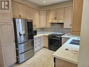 Mississauga (Churchill Meadows) apartment for rent - A kitchen with wooden cabinets and stainless steel appliances.