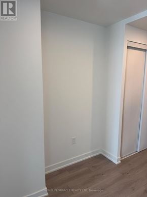 Mississauga (Mississauga Valleys) condo for rent - A room with a white wall and a wooden floor.