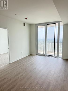 Mississauga (Mississauga Valleys) condo for rent - A room with a sliding glass door leading to a balcony.