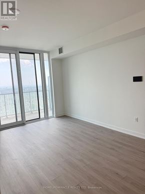 Mississauga (Mississauga Valleys) condo for rent - A room with a wooden floor and a large window.