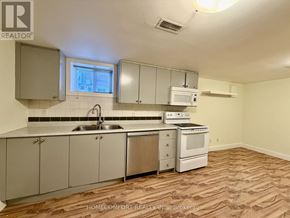Toronto (Corso Italia-Davenport) multi-family for rent - A kitchen with a sink, stove, and cabinets.
