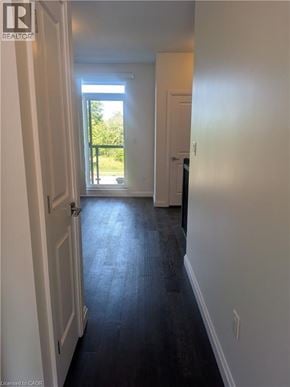 Stoney Creek townhouse for rent - A hallway with a door on the left and a window on the right.
