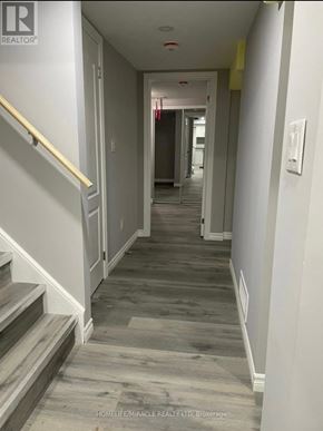 Kitchener apartment for rent - A hallway with a staircase on the left and a door on the right.