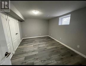 Kitchener apartment for rent - A room with wooden flooring and white walls.
