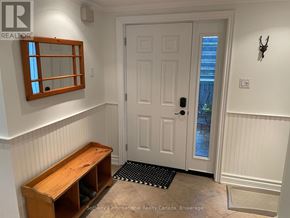 Collingwood condo for rent - A white door with a black mat in front of it.