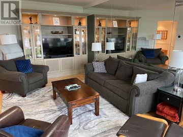 Collingwood condo for rent - A living room with a grey couch and a coffee table.