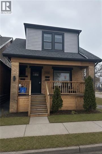 Hamilton apartment for rent - A house with a black front door and a small porch.