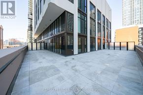 Toronto (Waterfront Communities) condo for rent - A modern building with a large open courtyard.