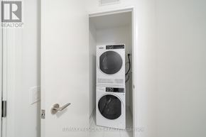 Toronto (Waterfront Communities) condo for rent - A washer and dryer are installed in a wall-mounted cabinet.