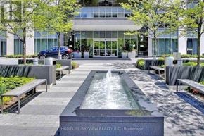 Toronto (Willowdale East) condo for rent - A fountain in the middle of a plaza outside a building with the sign HomeLife/Bayview Realty Inc Brokerage.