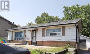 Toronto (L'amoreaux) apartment for rent - A small white house with a grey roof and a car parked in front.
