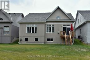 Georgina (Sutton & Jackson's Point) apartment for rent - A grey house with a deck and a red flag.