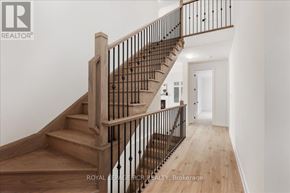 Georgina (Sutton & Jackson's Point) apartment for rent - A wooden staircase with a metal railing.