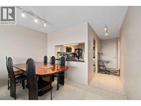 Burnaby apartment for rent - A dining room with a table and chairs and a kitchen in the background.