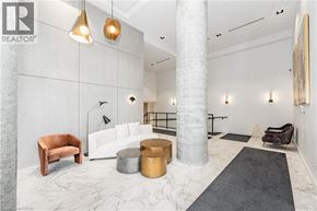 Kitchener condo for rent - A modern living room with a white marble floor and a white column.