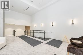 Kitchener condo for rent - A spacious room with a marble floor and a row of lights on the wall.