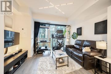 Toronto (Waterfront Communities) condo for rent - A living room with a black leather couch and a coffee table.