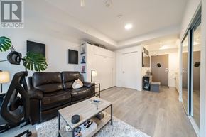 Toronto (Waterfront Communities) condo for rent - A living room with a black couch and a coffee table.