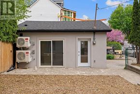 Toronto (Greenwood-Coxwell) apartment for rent - A small house with a grey roof and a grey door.