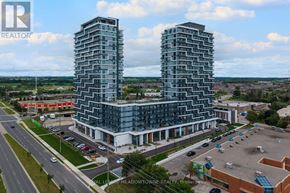 Markham (Greensborough) condo for rent - Two tall buildings are situated in front of a parking lot.