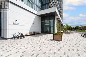 Markham (Greensborough) condo for rent - A modern building with a white exterior and a bicycle parked in front.