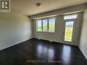 Brantford apartment for rent - A room with a sliding glass door leading to a grassy area.