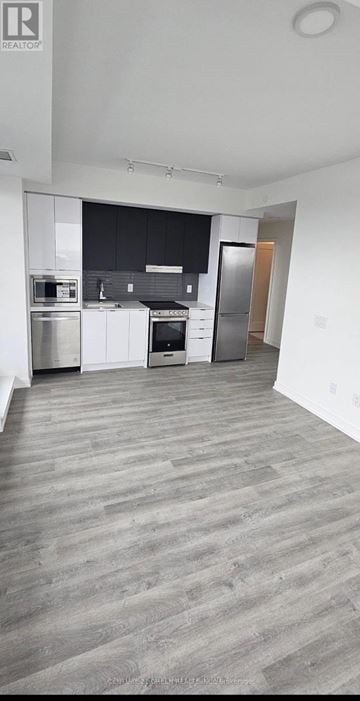 Mississauga (Hurontario) condo for rent - A spacious kitchen with a dining area and a door to the hallway.