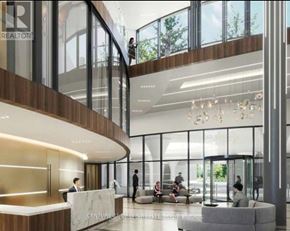 Mississauga (Hurontario) condo for rent - A modern office lobby with a reception desk and people sitting on a couch.