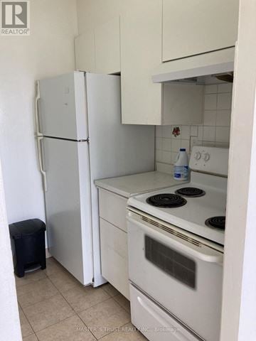 Toronto (Yorkdale-Glen Park) condo for rent - A white fridge and oven in a kitchen.