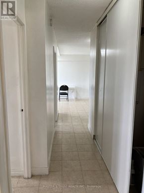 Toronto (Yorkdale-Glen Park) condo for rent - A hallway with a chair and a door.