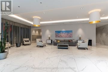 Toronto (High Park-Swansea) condo for rent - A spacious living room with a marble floor and a large painting on the wall.