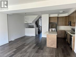 Brantford townhouse for rent - A kitchen with wooden floors and a white countertop.