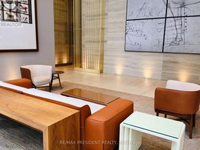 Toronto (Waterfront Communities) condo for rent - A room with a wooden table and chairs and a framed drawing on the wall.