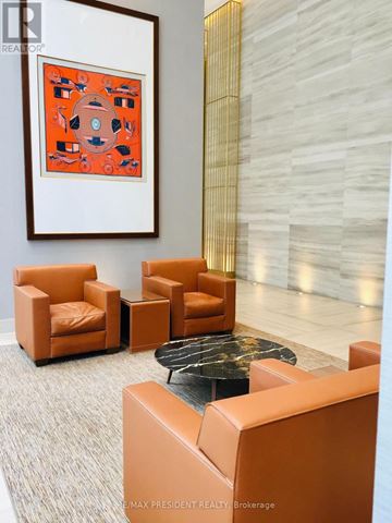 Toronto (Waterfront Communities) condo for rent - A living room with a grey carpet and a painting on the wall.