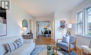 Toronto (Clairlea-Birchmount) apartment for rent - A living room with a white sofa and a wooden chair.