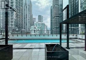 Toronto (Waterfront Communities) condo for rent - A pool on a balcony with a cityscape in the background.