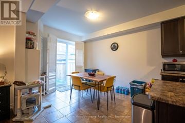 Milton (Fo Ford) townhouse for rent - A kitchen with a table and chairs in the middle of the room.