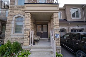 Milton (Fo Ford) townhouse for rent - A house with a stone facade and a black car parked in front.